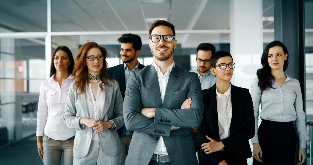 Managing from a Positive Perspective. Happy business people celebrating success at company