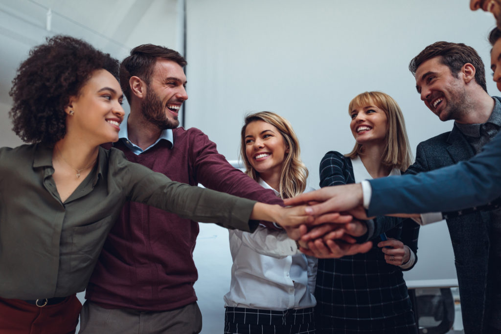 Workplace Excellence: Close up of a group of businesspeople stacking their hands on top of each other