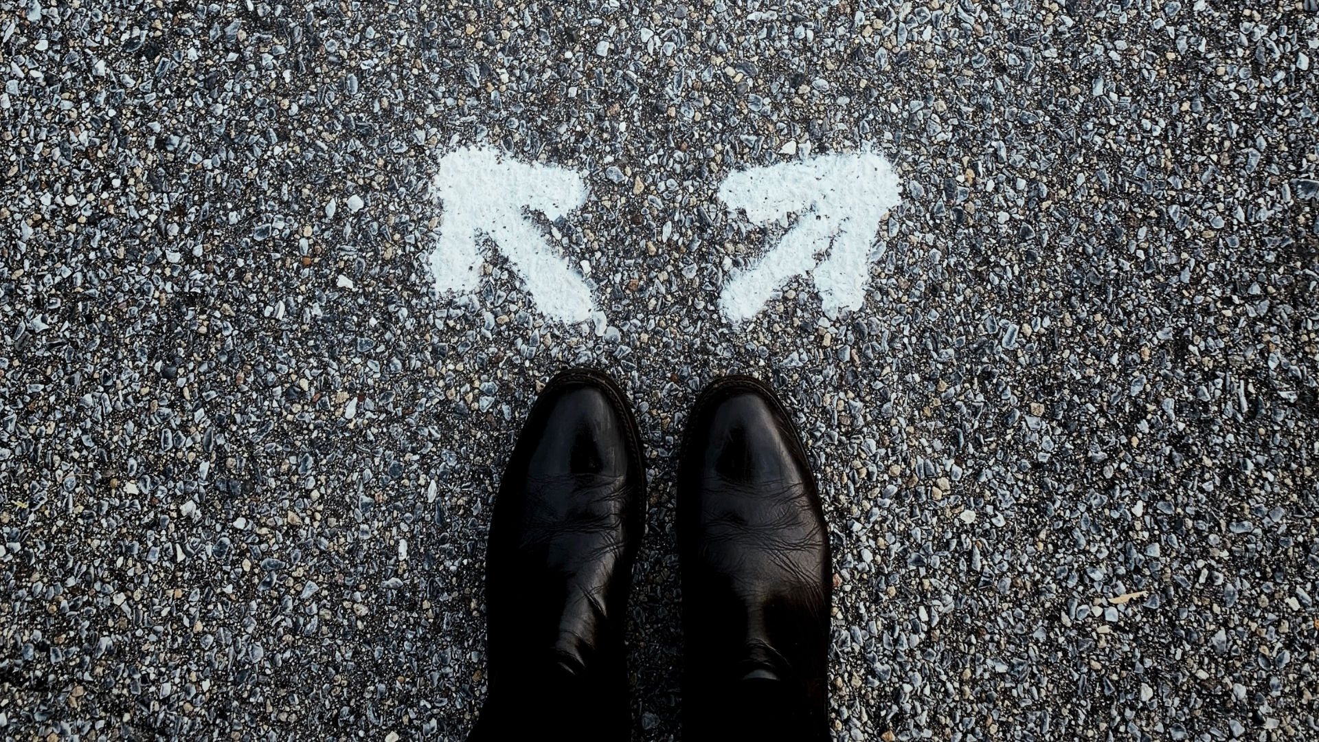 Person standing behind two arrows going opposite directions