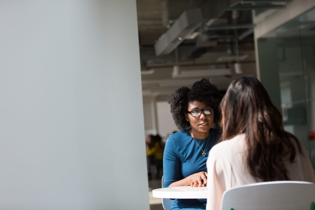 Woman sitting across the table from an interviewer