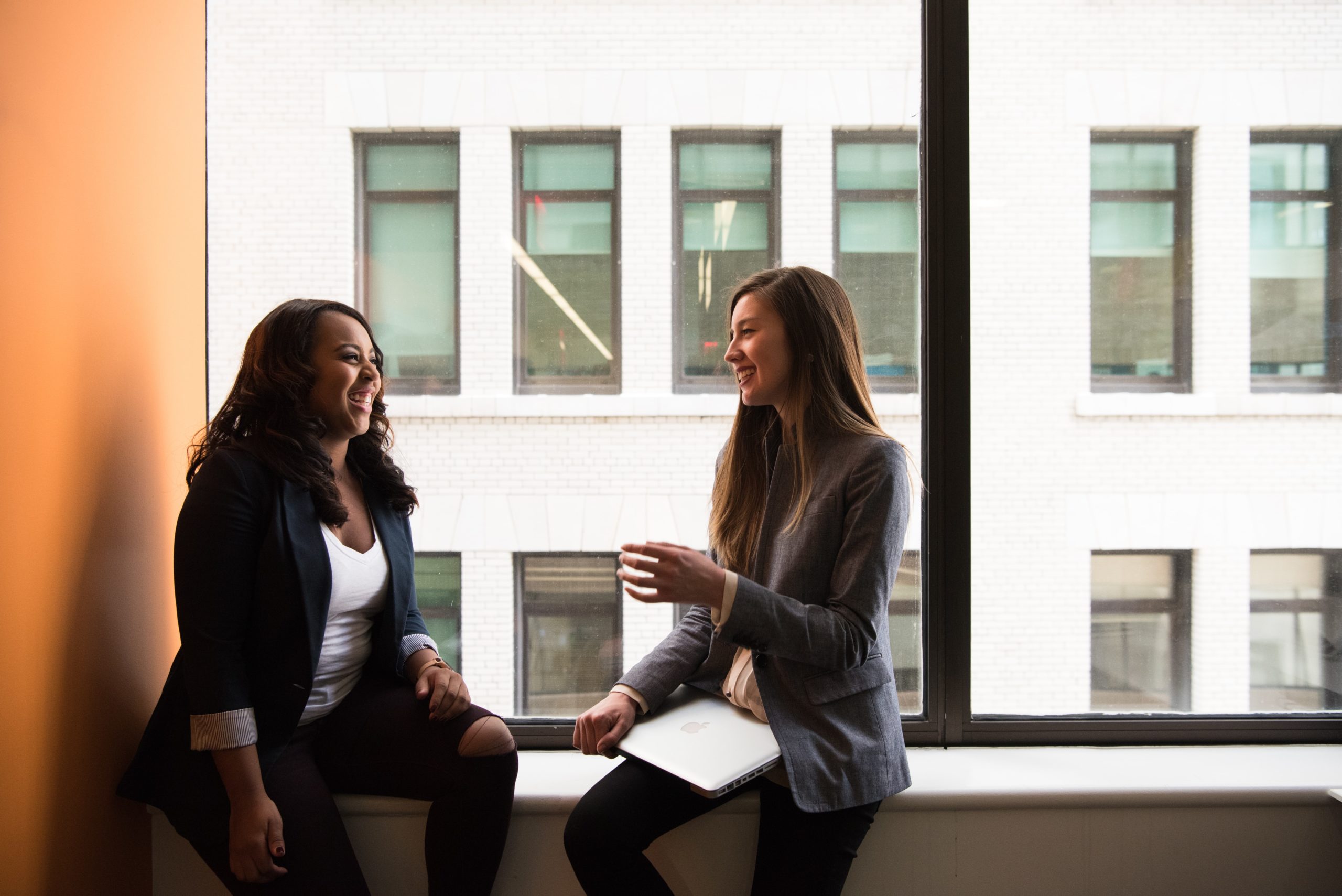 two women sitting and talking