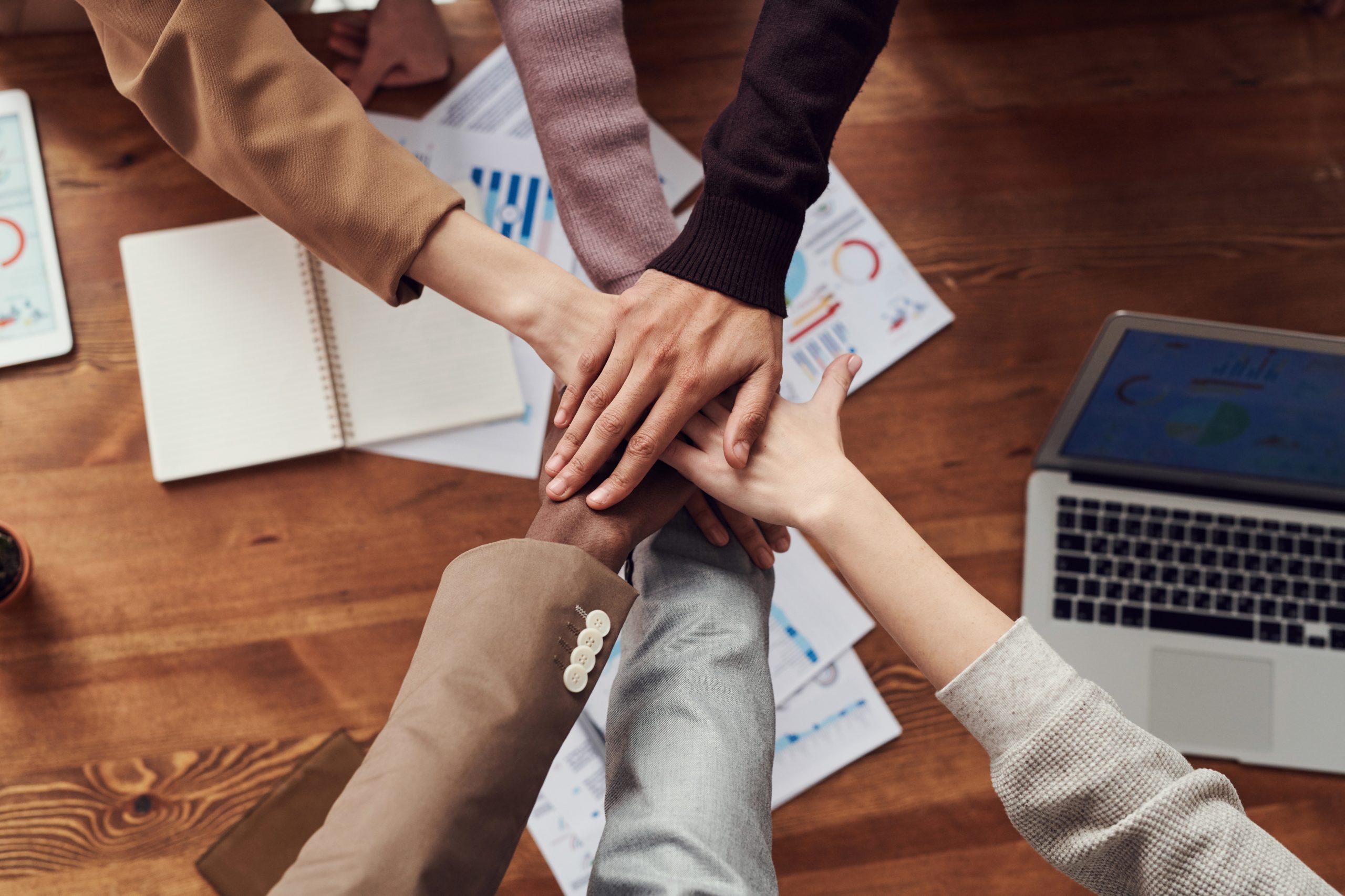 People stacking their hands in a circle like a team
