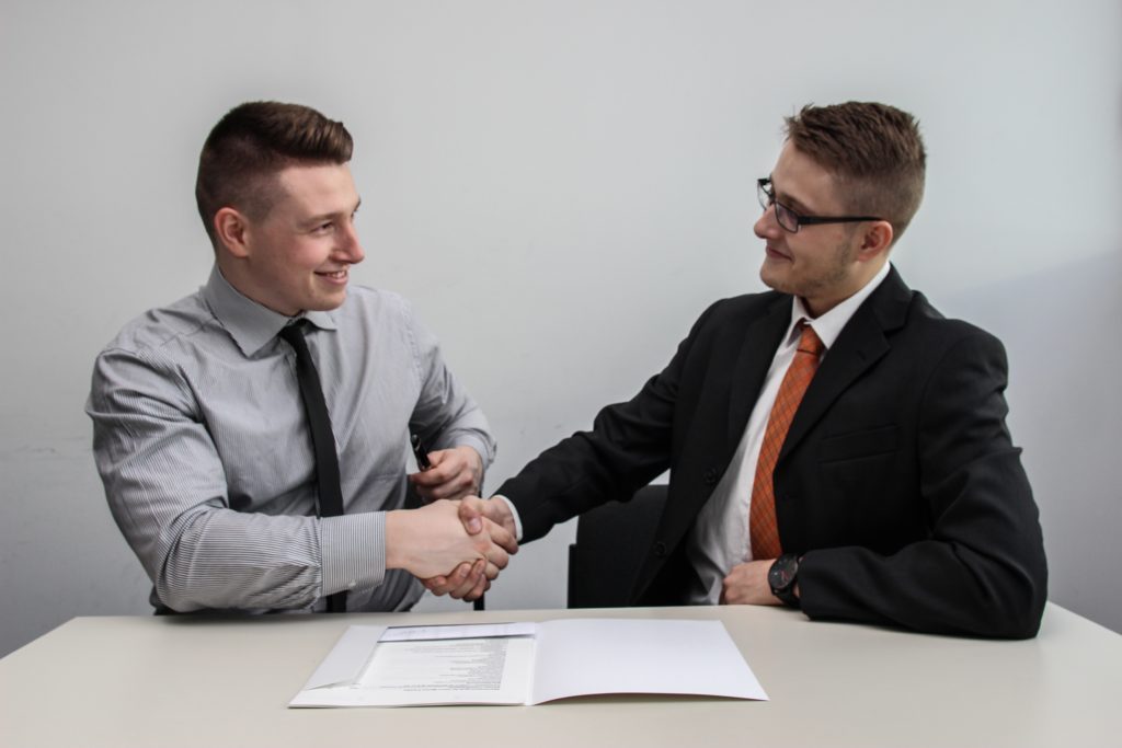 two men at interview shaking hands; next job interview